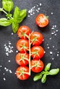 Fresh cherry tomatoes on a black background with spices. Top vie Royalty Free Stock Photo