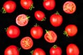 Fresh cherry tomatoes isolated on a black background whole and cut in half. Top view, layout Royalty Free Stock Photo