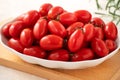 Fresh cherry tomatoes over white table background