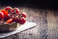 Fresh cherry tomatoes. Ripe tomatoes on oak wooden background