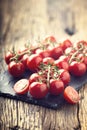 Fresh cherry tomatoes. Ripe tomatoes on oak wooden background