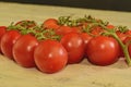 Fresh cherry tomatoes on rustic wooden background. White and black background Royalty Free Stock Photo