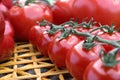 Fresh cherry tomatoes on a straw mat. Royalty Free Stock Photo