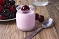 Cherry yogurt in glass, with fresh cherries