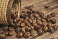 Fresh chestnuts in the basket falling on a brown wooden table Royalty Free Stock Photo