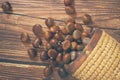 Fresh chestnuts in the basket falling on a brown wooden table Royalty Free Stock Photo