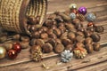 Fresh chestnuts in the basket falling on a brown wooden table, along with christmas decorations Royalty Free Stock Photo