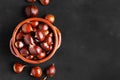 Fresh chestnuts in a clay bowl on black background Royalty Free Stock Photo