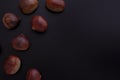 Fresh chestnuts on dark black background