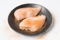 Fresh chicken breast fillets seasoned with spices on black dish Royalty Free Stock Photo