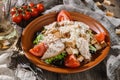 Fresh Chicken Caesar Salad of fresh vegetables with tomatoes, lettuce, croutons, grilled chicken breast, cheese parmesan and sauce Royalty Free Stock Photo