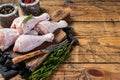 Fresh Chicken drumsticks legs with skin, raw poultry meat. Wooden background. Top view. Copy space Royalty Free Stock Photo