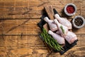 Fresh Chicken drumsticks legs with skin, raw poultry meat. Wooden background. Top view. Copy space Royalty Free Stock Photo