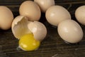a chicken egg smashed on a black table, a broken cracked chicken egg spreads on a black wooden board Royalty Free Stock Photo