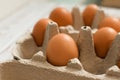 Fresh chicken eggs in a cardboard box or tray made from natural materials.