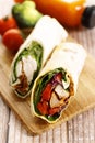 Fresh chicken fajita wrap sandwiches on wooden plank Royalty Free Stock Photo