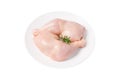 Three raw whole chicken legs on a white plate on a white isolated background. Fresh chicken legs. Royalty Free Stock Photo