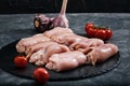 Fresh chicken on a slate tray on the table. Fresh meat concept. Photos for grocery stores