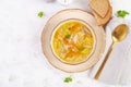 Fresh chicken soup with vegetables and stelline pasta in a bowl with carrot and parsley.