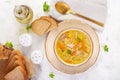 Fresh chicken soup with vegetables and stelline pasta in a bowl with carrot and parsley.