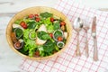 Fresh chicken vegetable salad with fresh tomato, cucumber, lettuce, onion, spinach, sesame, cheese on plate with spoon, fork and k Royalty Free Stock Photo