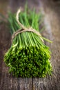 Fresh chives bunch on oldv wooden background Royalty Free Stock Photo