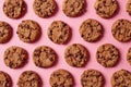 Fresh chocolate chip cookies pattern on pink background