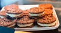 Fresh chocolate cookies in a glass showcase in a cafe or shop. Close-up. Selective focus Royalty Free Stock Photo