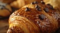 Fresh chocolate croissant on wooden surface. Close-up food photography