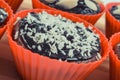 Fresh chocolate muffins with desiccated coconut and dried almonds. Delicious dessert