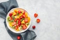 Fresh chopped fruit salad in a bowl.