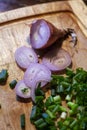 Fresh chopped shallots, parsley and green onions on a wooden board.