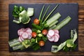 Fresh chopped vegetables on a stone board, food design fresh vegetable salad, vegetarian food on a natural surface