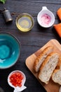 Fresh ciabatta bread with blue bowl and ingredients served at dark wooden table. meditarranean cuisine. flat lay
