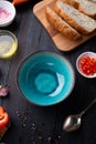 Fresh ciabatta bread  with blue bowl and ingredients served at dark wooden table. meditarranean cuisine. flat lay Royalty Free Stock Photo