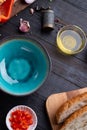 Fresh ciabatta bread  with blue bowl and ingredients served at dark wooden table. meditarranean cuisine. flat lay Royalty Free Stock Photo