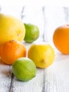 Fresh citrus fruits on white rustic wooden background Royalty Free Stock Photo