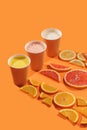 Fresh citrus juices orange, grapefruit, lemon with citrus fruits. concept on orange background. isolate. Take away Royalty Free Stock Photo