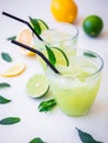 Fresh citrus lemonade made of limes and lemons in glasses. Royalty Free Stock Photo