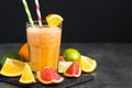 Fresh citrus smoothie juice at dark background. Royalty Free Stock Photo