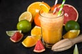 Fresh citrus smoothie juice at dark background. Royalty Free Stock Photo