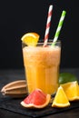 Fresh citrus smoothie juice at dark background. Royalty Free Stock Photo