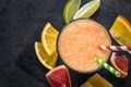 Fresh citrus smoothie juice at dark background. Royalty Free Stock Photo