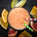 Fresh citrus smoothie juice at dark background. Royalty Free Stock Photo