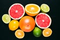 Fresh citrus stihli. Lemons, limes, grapefruit and orange on a black background Royalty Free Stock Photo