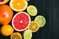 Fresh citrus stihli. Lemons, limes, grapefruit and orange on a black background Royalty Free Stock Photo