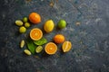 Fresh citruses on dark background. Oranges and limes. Top view Royalty Free Stock Photo