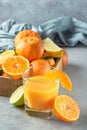 Fresh citruses. Tangerines, lime, lemon and juice glass Royalty Free Stock Photo