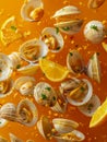 Fresh Clams with Lemon Segments and Parsley Sprinkled with Seasoning on Vibrant Orange Background Royalty Free Stock Photo