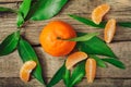 Fresh Clementine or Mandarin orange with leaves on wooden background Royalty Free Stock Photo